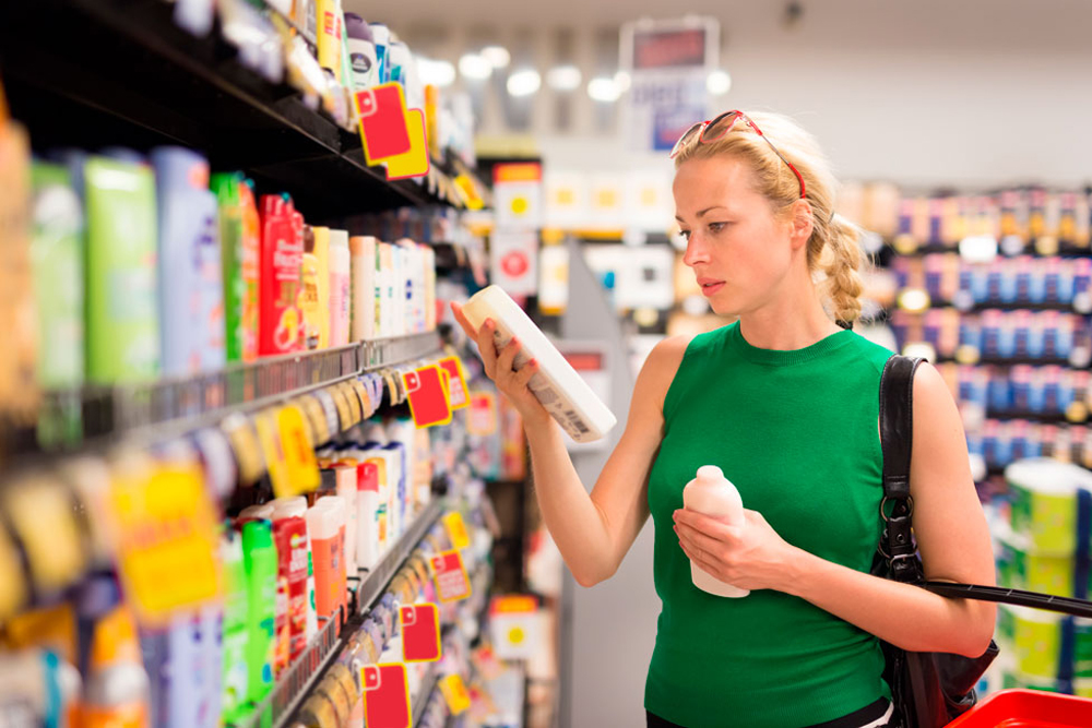 Woman in supermarket with hygiene products